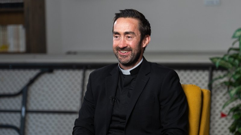 Michael Croghan, a new priest ordained on May 31, sits during a video interview on April 9. (Isabel Cacho)