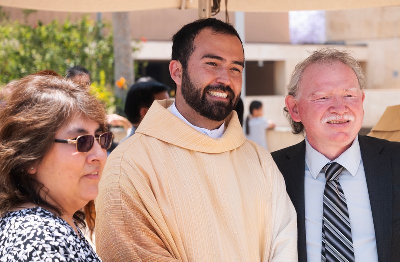 Father Christian Morquecho poses with loved ones following the new priests ordination Mass on May 31.(Victor Alemán)