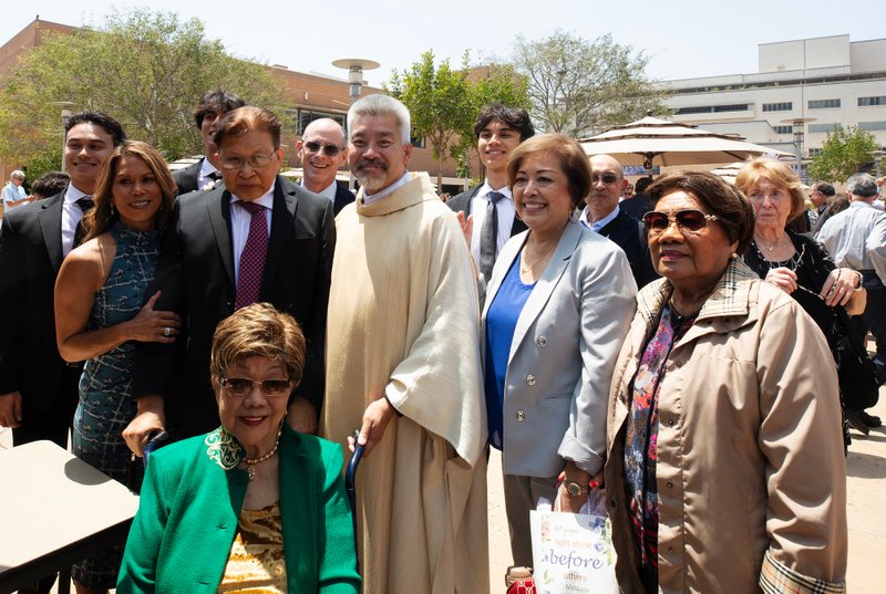 Father Joseph Cruz poses with family and loved ones following the new priests ordination Mass on May 31. (Victor Alemán)