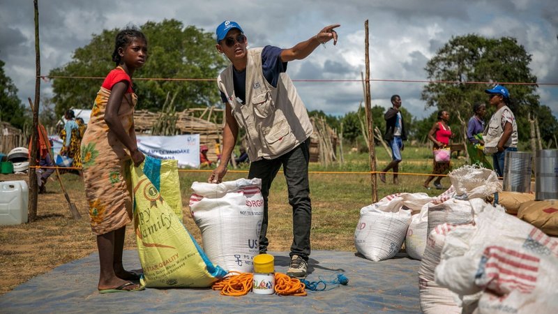 A Catholic Relief Services worker is pictured in a file photo helping a young woman at a food distribution area in Marojela village, located in the Marolinta commune in southern Madagascar's Beloha District. (OSV News photo/Jim Stipe, courtesy Catholic Relief Services)