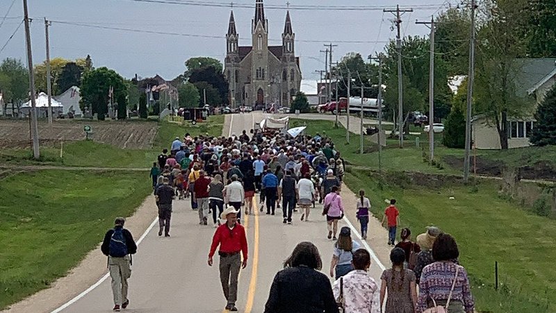 Pilgrims walk along a road towards Sts. Peter and Paul in Petersburg, Iowa, May 24, 2024. (OSV News photo/courtesy National Eucharistic Pilgrimage)