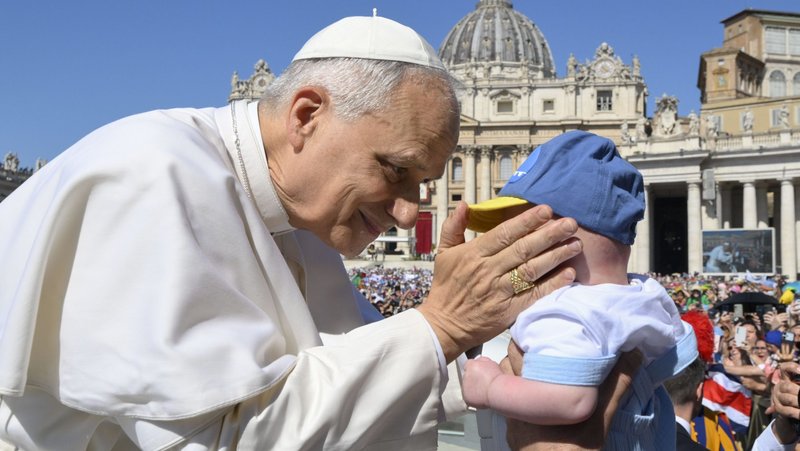 Pope Leo XIV greets a child as he rides in the popemobile before celebrating Mass in St. Peter’s Square at the Vatican June 1, 2025, as part of the Jubilee of Families, Children, Grandparents and the Elderly. (CNS photo/Vatican Media)