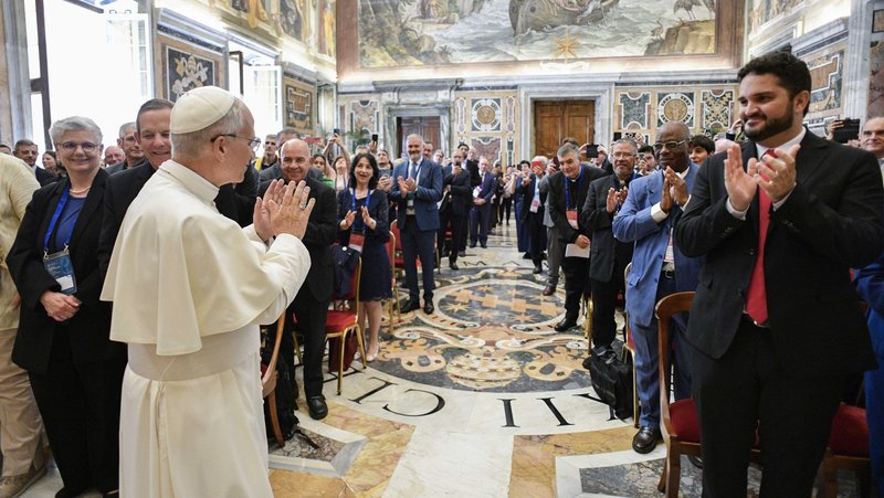 Pope Leo XIV waves as he arrives for a meeting with leaders of 115 international Catholic associations, ecclesial movements and new communities in the Vatican's Clementine Hall June 6, 2025. (CNS photo/Vatican Media)