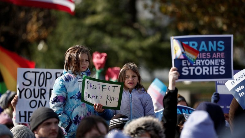 People hold signs as the U.S. Supreme Court hears arguments over an appeal by then-U.S. President Joe Biden's administration of a lower court’s decision upholding a Republican-backed ban in Tennessee on gender-affirming medical care for transgender minors, in Washington, D,C., Dec. 4, 2024. The nation’s highest court on June 18 upheld the Tennessee state law. (OSV News/Benoit Tessier, Reuters)