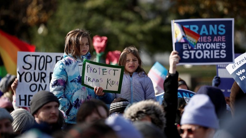 People hold signs as the U.S. Supreme Court hears arguments over an appeal by then-U.S. President Joe Biden's administration of a lower court's decision upholding a Republican-backed ban in Tennessee on gender-affirming medical care for transgender minors, in Washington Dec. 4, 2024. The nation's highest court on June 18, 2025, upheld the Tennessee state law. (OSV News photo/Benoit Tessier, Reuters)