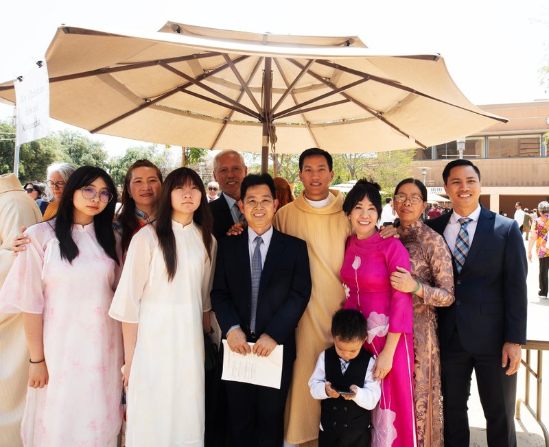 Father Quoc Vo poses with family and loved ones following the new priests ordination Mass on May 31. (Victor Alemán)