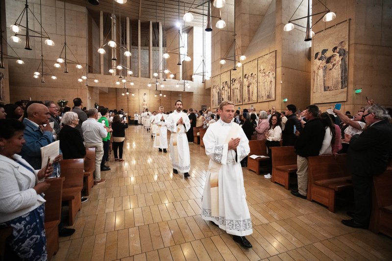 The eight men to be ordained as new priests process into the Cathedral of Our Lady of the Angels for their ordination Mass on May 31. (Victor Alemán)