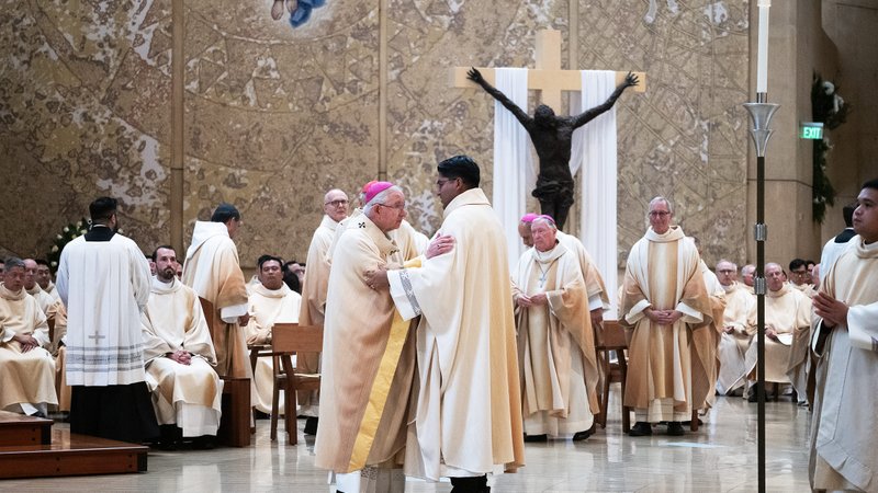 Archbishop José H. Gomez offers the kiss of peace to newly ordained Father Jorge Moncada during the ordination Mass at the Cathedral of Our Lady of the Angels on May 31. (Victor Alemán)