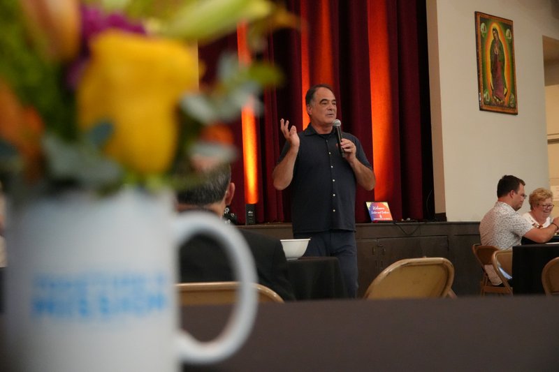 Tom Costanzo, who lost his home in the Eaton Fire, speaks during a pre-Mass dinner at Sacred Heart Church in Altadena during the National Eucharistic Pilgrimage's stop on June 20. (Katie Trejo)