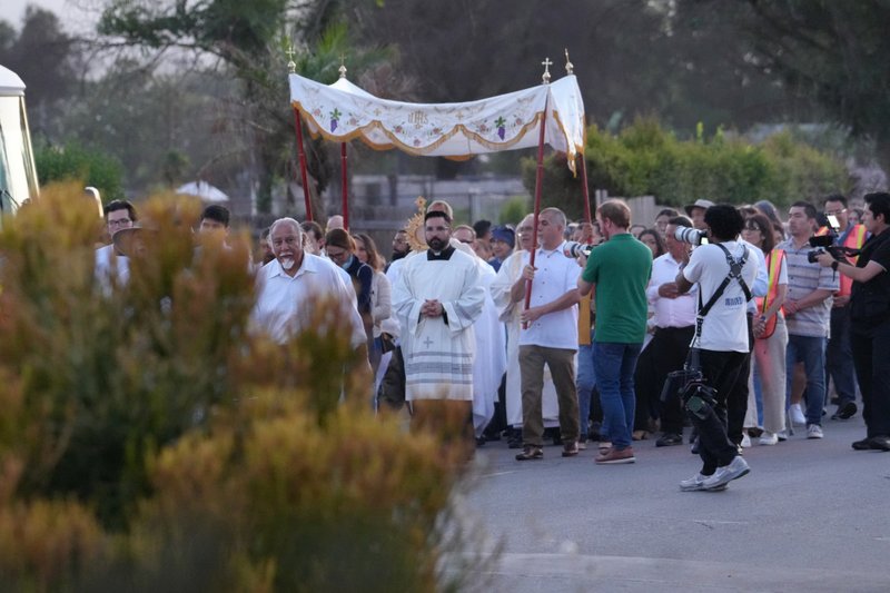 A Eucharistic procession as part of the National Eucharistic Pilgrimage travels through the streets of Altadena that were burned in the Eaton Fire on June 20. (Katie Trejo)