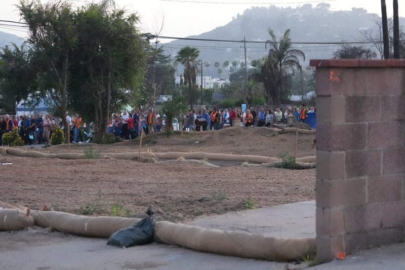 Hundreds participating in the National Eucharistic Pilgrimage procession through the streets of Altadena on June 20 passed several empty lots that once contained the homes burned down in the Eaton Fire. (Katie Trejo)
