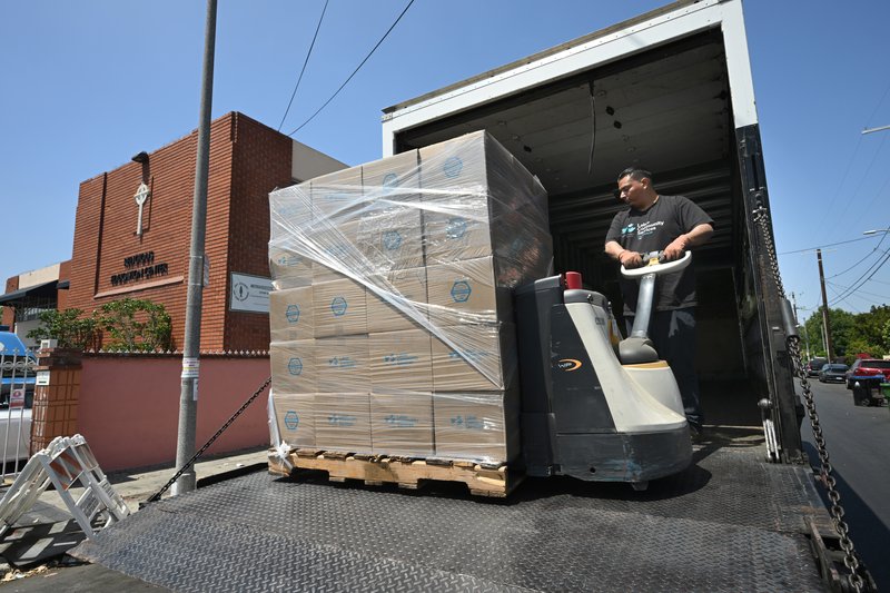 A Labor Community Services Los Angeles worker delivers donations at St. Patrick Church near downtown LA. (John McCoy)
