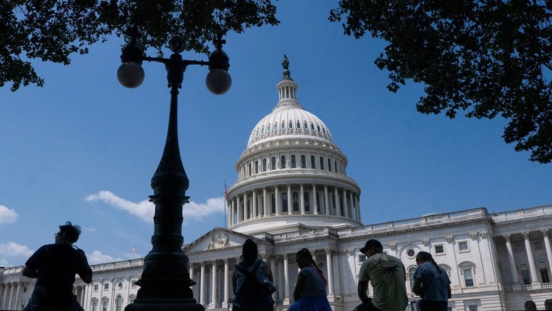 Visitors to the U.S. Capitol rest in the shade on Capitol Hill in Washington June 25, 2025. (OSV News photo/Nathan Howard, Reuters)