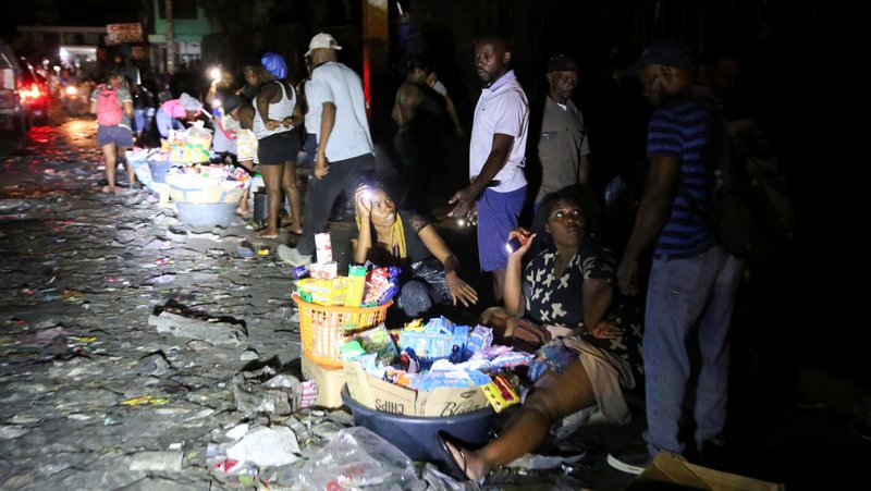 People sell goods on a street during a June 18, 2025, blackout in Port-au-Prince, Haiti's capital, after residents from a nearby town stormed a dam and cut power in protest over government inaction against gang violence in the country. (OSV News photo/Jean Feguens Regala, Reuters)