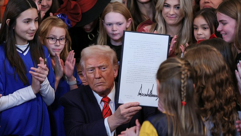 U.S. President Donald Trump holds up a signed executive order in the East Room at the White House in Washington Feb. 5, 2025, that bans transgender athletes from competing in women's sport. The Supreme Court said July 3 that it would take up cases from Idaho and West Virginia concerning state laws requiring student athletes to compete on sports teams that correspond to their biological sex rather than their gender identity. (OSV News photo/Leah Millis, Reuters)