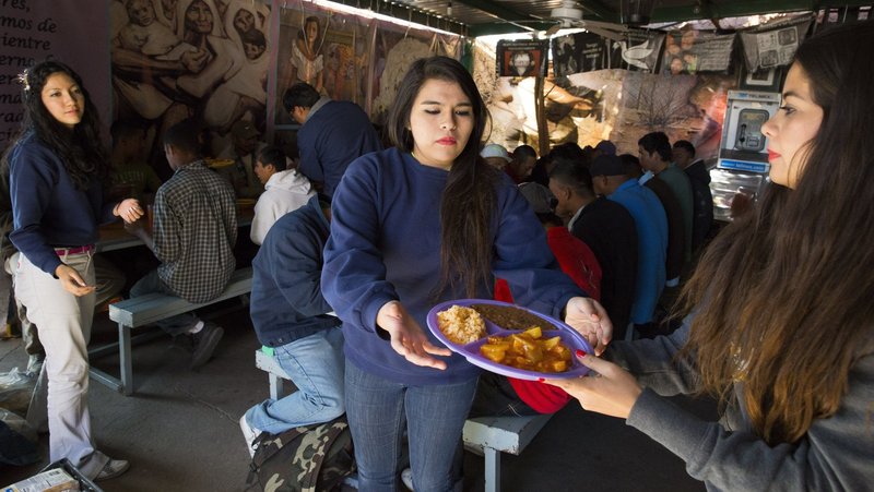 In this file photo, Kino Teens volunteers are pictured serving dinner to recently deported migrants in the kitchen and dining hall of Centro de Atención al Migrante Deportado (Aid Center for Deported Migrants) in Nogales, in the Mexican state of Sonora. (OSV News photo/Nancy Wiechec)