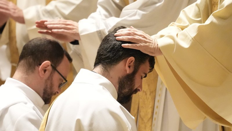 A priest lays hands on Deacon Kieran Halloran during his ordination to the priesthood at St. Ignatius Loyola Church in New York City June 14, 2025. (OSV News/Gregory A. Shemitz)