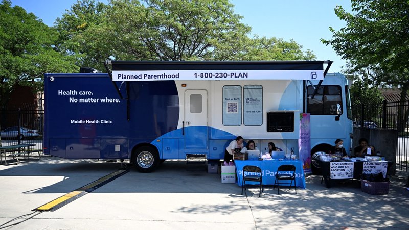 People check computers outside of a Planned Parenthood mobile clinic in Chicago Aug. 19, 2024. U.S. District Judge Indira Talwani ruled July 28, 2025, that Planned Parenthood clinics nationwide must continue to be reimbursed for Medicaid funding despite recent passage of the One Big Beautiful Bill that included a provision stripping those funds for one year. Talwani's new ruling expanded her previous injunction. (OSV News photo/Vincent Alban, Reuters)