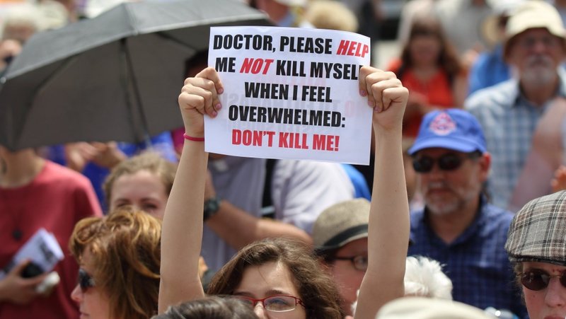 A woman is pictured in a file photo holding up a sign during a rally against assisted suicide on Parliament Hill in Ottawa, Ontario. A Canadian lawmaker says pushback has been growing against expanding assisted suicide to include those with mental illnesses in the weeks since she held a press conference July 9, 2025, in British Columbia on a bill she's introduced to block mental health as a sole criteria. (OSV News photo/Art Babych)