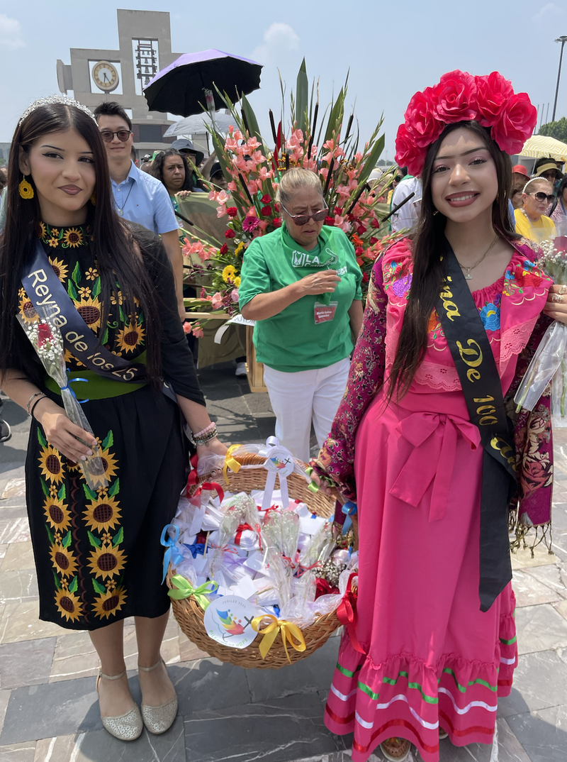LA Catholics hold flowers and prayer petitions before processing into the Basilica of Our Lady of Guadalupe in Mexico City for a special Mass during the archdiocese's annual pilgrimage to Mexico on July 4. (Adrian Marquez Alarcon)