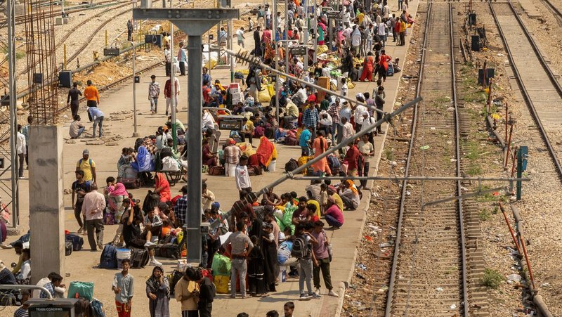 People sit on a platform as they wait to board a train at a railway station in Jammu, India, May 10, 2025. Two Catholic nuns and an Indigenous youth who were arrested on July 25 at Durg railway station in Chhattisgarh state were granted bail and released Aug. 2 under strict conditions. They were arrested for alleged human trafficking and forced conversion in central India. (OSV News photo/Adnan Abidi, Reuters)
