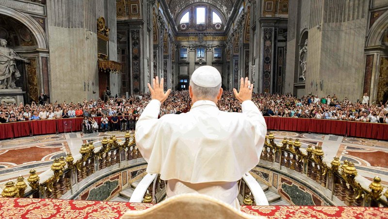 Pope Leo XIV greets pilgrims gathered inside St. Peter’s Basilica at the Vatican Aug. 13, 2025, after his weekly general audience. The pope visited them at the conclusion of the audience to offer his blessing, as the Paul VI hall had reached full capacity. (CNS photo/Vatican Media)