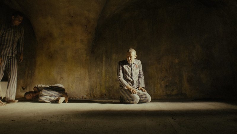 Polish actor Marcin Kwasny portrays Polish Conventual Franciscan Father Maximilian Kolbe in the death starvation cell at the Nazis’ main Auschwitz concentration camp, where he died Aug. 14, 1941. The priest’s last moments are the core story of a new movie about him titled “Triumph of the Heart” by American filmmaker Anthony D’Ambrosio. (OSV News photo/courtesy Rafael Film)
