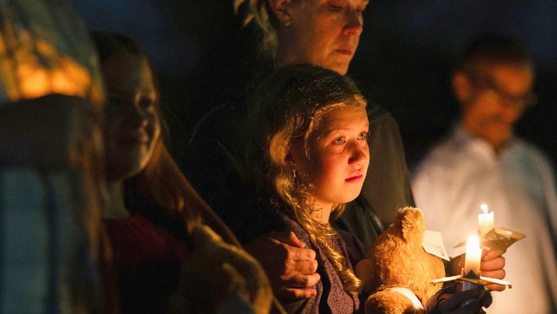A girl holds a candle during a vigil at Lynnhurst Park in Minneapolis Aug. 27, 2025, following a shooting earlier in the day at Annunciation Church. (OSV News photo/Tim Evans, Reuters)