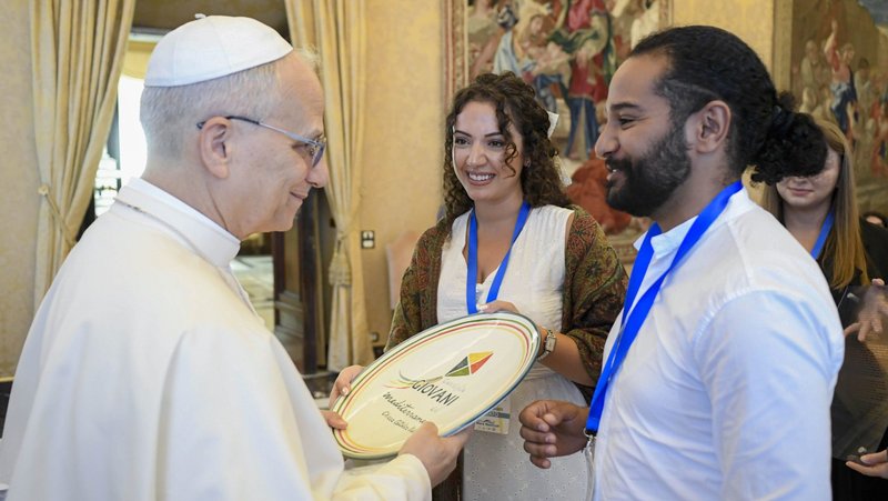 Young adults present Pope Leo XIV with a plate decorated with the logo of the Youth Council of the Mediterranean after an audience at the Vatican Sept. 5, 2025. The council, coordinated by the Italian bishops, includes young adult representatives from more than a dozen Mediterranean countries. (CNS photo/Vatican Media)