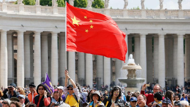 A visitor waves the flag of China in St. Peter's Square at the Vatican in this file photo from May 22, 2019. (CNS photo/Paul Haring)