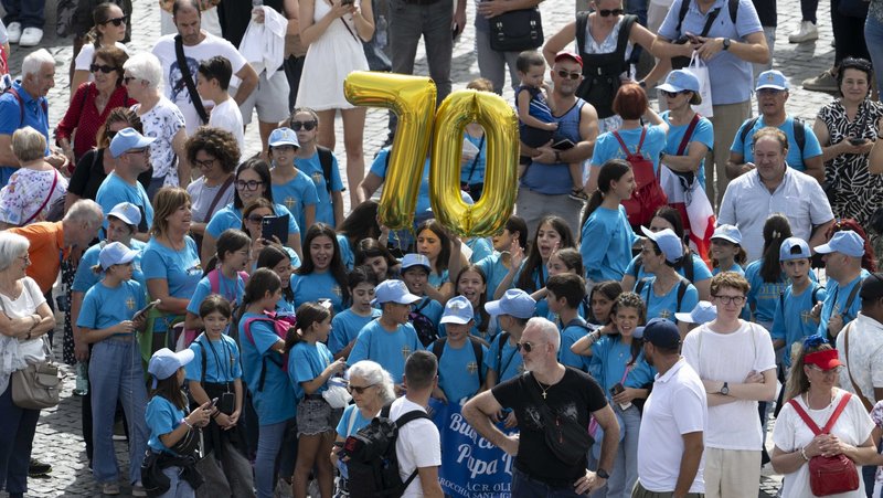A group of children from an Italian parish holds up two gold mylar balloons of the numbers "7" and "0" as they join other visitors in St. Peter's Square at the Vatican for Pope Leo XIV's recitation of the Angelus prayer and to wish him a happy 70th birthday Sept. 14, 2025. (CNS photo/Vatican Media)