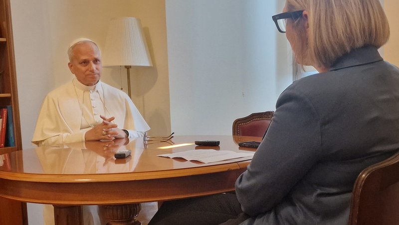 Pope Leo XIV sits with Elise Allen, senior correspondent at Crux, for an interview at the pope's residence inside the Vatican's Palazzo Sant'Uffizio July 30, 2025. The biography of the pope is titled, "Leo XIV: Citizen of the World, Missionary of the XXI Century," and it will be published in Spanish by Penguin Peru Sept. 18. English and Portuguese editions of the book will be released in early 2026. (CNS photo/courtesy Crux)