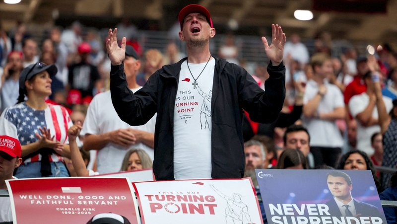 A man prays as thousands gather at a memorial service for slain conservative activist Charlie Kirk at State Farm Stadium in Glendale, Arizona, Sept. 21. (OSV News / Daniel Cole, Reuters)
