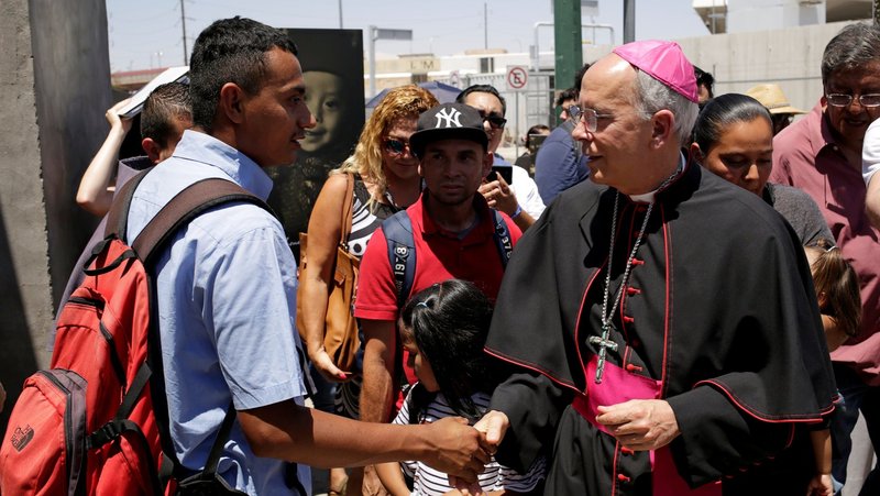 Bishop Mark J. Seitz of El Paso, Texas, greets a Salvadoran migrant in Ciudad Juarez, Mexico, June 27, 2019, who was deported from the U.S. after crossing the Paso del Norte international border from El Paso. (OSV News photo/Jose Luis Gonzalez, Reuters)