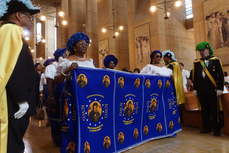 Attendees carry a banner during the procession to kick off the “One Mother, Many Peoples” Mass at the Cathedral of Our Lady of the Angels on Sept. 6, which celebrated the diverse cultures, organizations, and ethnic ministries in the Archdiocese of Los Angeles. (Reese Cuevas/Archdiocese of Los Angeles)