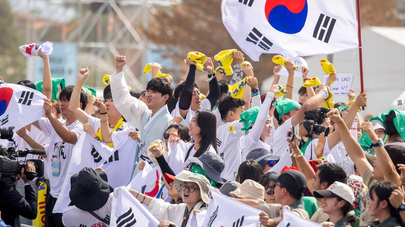 Pilgrims from South Korea wave flags and cheer as they participate in a Mass closing the Jubilee of Youth in Rome’s Tor Vergata neighborhood Aug. 3, 2025. (CNS photo/Pablo Esparza)