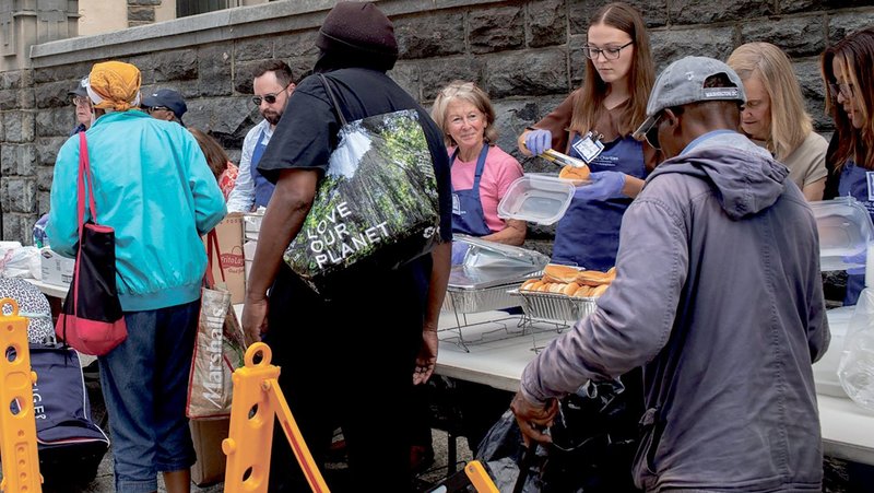 Volunteers serve meals to guests at Catholic Charities’ St. Maria’s Meals program Aug. 20, 2025. Every Wednesday afternoon outside Catholic Charities headquarters in Washington, the St. Maria’s Meals program serves hot and nutritious meals to people experiencing homelessness or food insecurity. Catholic Charities of the Archdiocese of Washington has expanded its homeless shelter capacity in the District of Columbia as homeless encampments are being removed across the nation’s capital. (OSV News photo/courtesy of Catholic Charities)