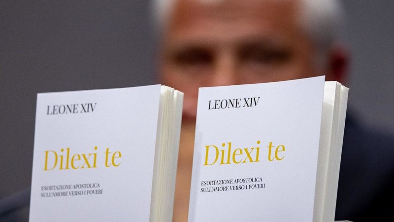 Copies of the Italian translation of "Dilexi Te" ("I Have Loved You"), Pope Leo XIV's apostolic exhortation, are seen in front of Cardinal Konrad Krajewski, prefect of the Dicastery for the Service of Charity, at a Vatican news conference Oct. 9, 2025. (CNS photo/Pablo Esparza)