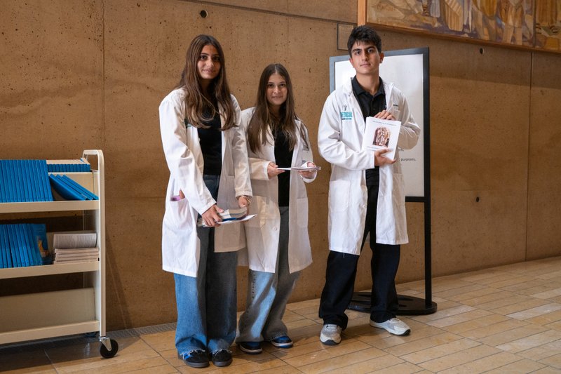 Volunteers hand out programs for the Healthcare Professionals Mass, known as the White Mass, at the Cathedral of Our Lady of the Angels on Oct. 12. (Lizzie Friedrich)