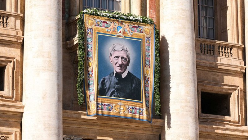A tapestry of St. John Henry Newman hangs from the facade of St. Peter’s Basilica at the Vatican Nov. 1, 2025, during the Mass in which Pope Leo XIV declared the 19th-century English cardinal and theologian a doctor of the church. The liturgy concluded the Jubilee of the World of Education. (CNS photo/Lola Gomez)