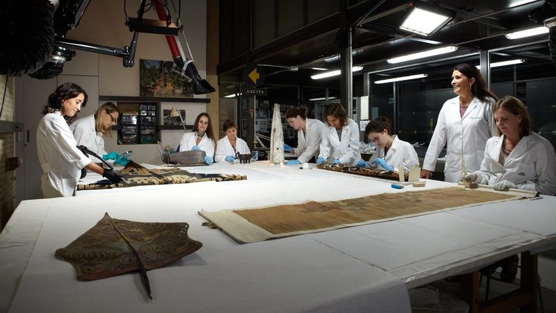 Expert restorers work in the conservation laboratory for ethnological materials at the Vatican Museums in this file photo from 2013. Many of the 100,000 artifacts sent to the Vatican via missionaries over the centuries are made of delicate materials such as ostrich plumes, leather and glass beads. (CNS photo/courtesy Vatican Museums)
