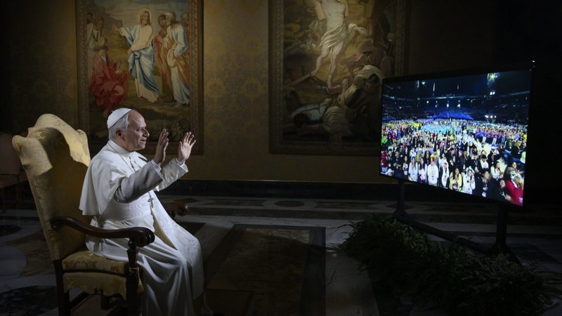 Pope Leo XIV waves at 16,000 young people gathered at the National Catholic Youth Conference in Indianapolis as he holds a livestreamed question-and-answer session with them from the Vatican Nov. 21, 2025. (CNS photo/Vatican Media)