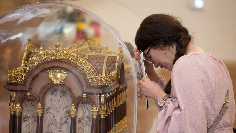 A woman venerates in front of the St. Thérèse reliquary at the Sacred Heart Retreat House in Alhambra on Oct. 13 during a U.S. tour of the saint's relics. (Jeffrey Bruno)