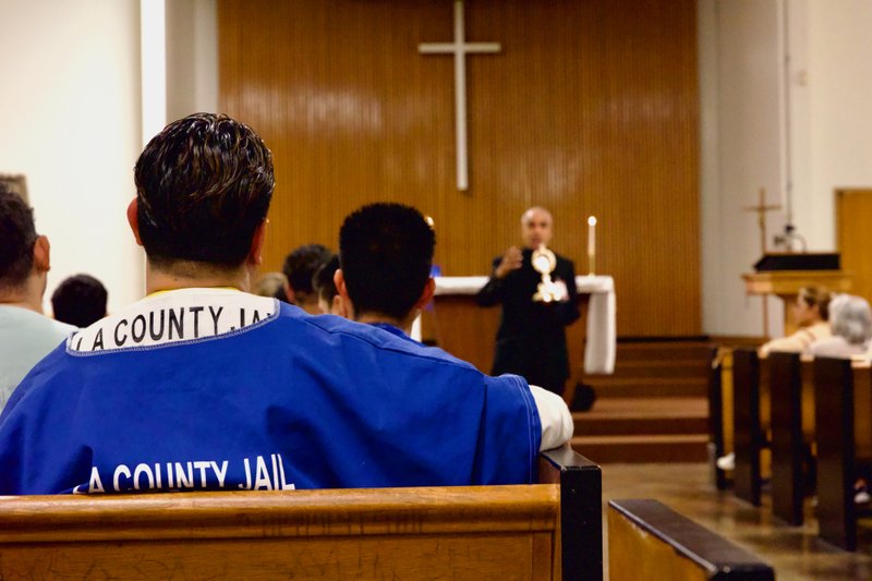 Msgr. Anthony Figueiredo, a priest in Assisi, Italy, speaks to inmates at LA Men’s Central Jail about the life of St. Carlo Acutis before Mass Oct. 20. (Reese Cuevas)