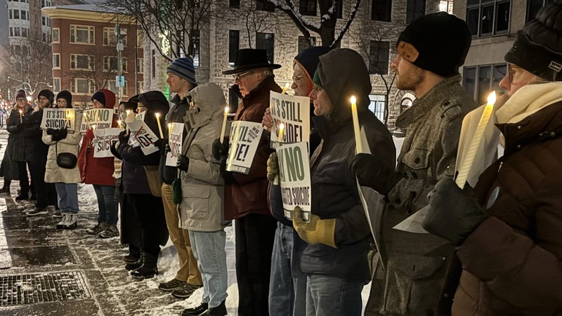 People attend a candlelight vigil outside the Sen. John H. Hughes Office Building in downtown Syracuse, N.Y., Dec. 4, 2025, to speak out against a controversial bill that, should it become law, would allow physicians to assist terminally ill adults as young as age 18 to die by suicide. (OSV News/Tami S. Scott, The Catholic Sun)