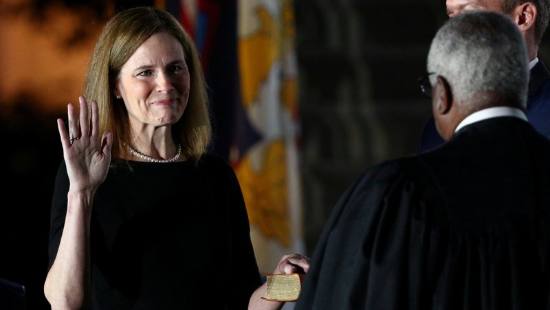 Judge Amy Coney Barrett holds her hand on the Bible as she is sworn in as an associate justice of the U.S. Supreme Court by Supreme Court Justice Clarence Thomas at the White House in Washington Oct. 26, 2020. (CNS photo/Tom Brenner, Reuters)