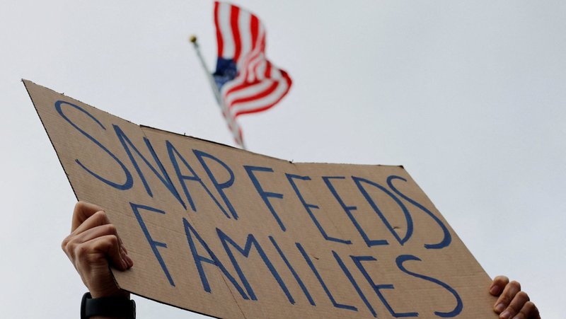 A man holds a sign during "A Rally for SNAP" on the steps of the Massachusetts Statehouse in Boston Oct. 28, 2025. (OSV News/Brian Snyder, Reuters)
