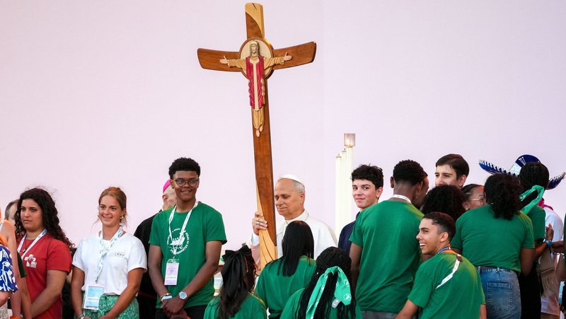 Pope Leo XIV holds the Jubilee Cross as young people gather around him during a prayer vigil at Tor Vergata in Rome Aug. 2, 2025, part of the Jubilee of Youth celebrations. (CNS photo/Lola Gomez)