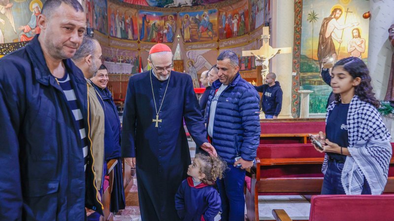 Cardinal Pierbattista Pizzaballa, Latin patriarch of Jerusalem, greets a child as he visits the compound of Gaza City's Holy Family Parish during his Christmas pastoral visit Dec. 19, 2025. He arrived prior to Christmas in a sign of closeness with a community that endured two years of war. (OSV News/courtesy Latin Patriarchate of Jerusalem)