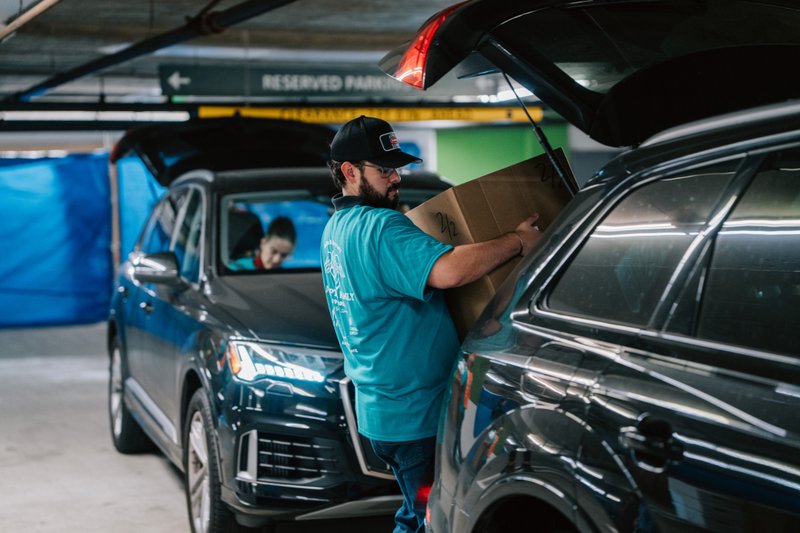 Volunteers carry donations of gifts, clothing, and more during the annual Adopt-a-Family LA distribution event on Dec. 13 at the Cathedral of Our Lady of the Angels. (Peter Lobato)